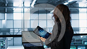 Technician in data center using AI tech on tablet