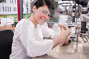 Technician at work in a dental lab or workshop producing a prostheis