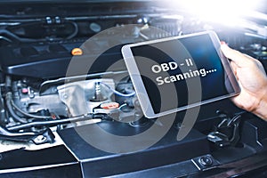 Technician diagnostics of code failure with OBD2 scanner technology on tablet