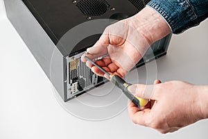 Technician disassemble computer with a screwdriver for problems diagnostic