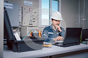 Technician is download data from the Solar panel performance check tool to analyze on a computer so that the power generation can