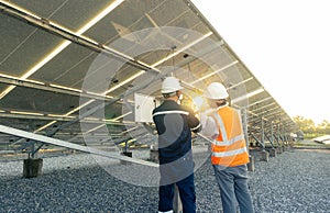 Technician with engineer are check the performance of the solar panels in the solar plant, Alternative energy to conserve the