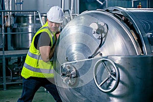 Technician engineer male worker working in boiler room gas pipe checking service routine in industry factory