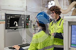 technician engineer training tralking together. worker technician team control operate industry robot arm computer machine