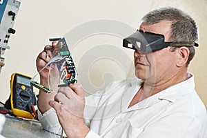 Technician engineer at work with microchip