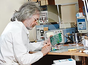 Technician engineer at work with microchip