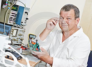 Technician engineer at work with microchip