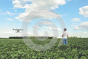 Technician farmer use wifi computer control agriculture drone on green field