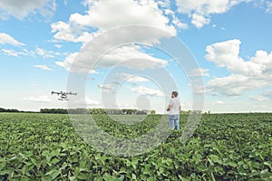 Technician farmer use wifi computer control agriculture drone on green field