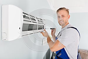 Technician Fixing Air Conditioner