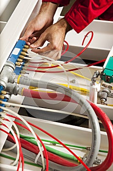 Technician fixing cabling and wiring circuit photo
