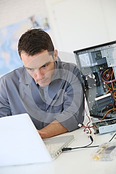 Technician fixing computer hard disc