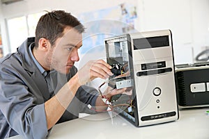 Technician fixing hard drive photo