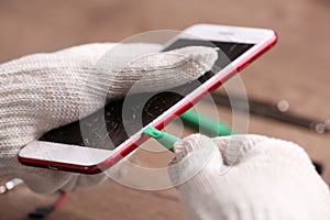 Technician fixing mobile phone at table. Device repair service