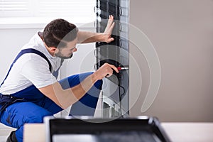 Technician Fixing Refrigerator