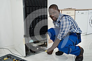 Technician Fixing Refrigerator