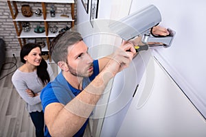 Technician Fixing Security Camera