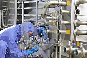 Technician fixing valves in plant