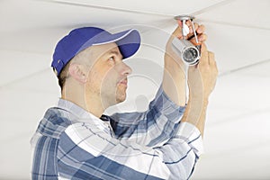 technician fixing video surveillance camera