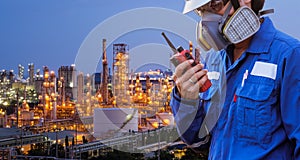 Technician with gas mask and walkie talkieagainst petrochemical