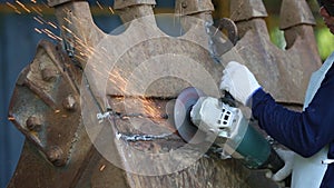 Technician grinding metal in industrial plant, Electric wheel grinding on steel structure in factory, steel grinding
