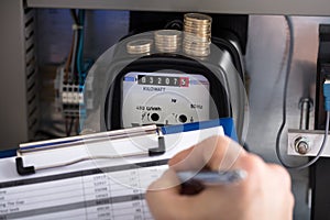 Technician Hand Writing Reading Of Meter