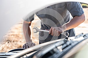 Technician hands of car mechanic in doing auto repair service and maintenance worker repairing vehicle with wrench, Service and