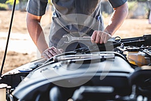 Technician hands of car mechanic in doing auto repair service and maintenance worker repairing vehicle with wrench, Service and