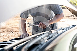 Technician hands of car mechanic in doing auto repair service and maintenance worker repairing vehicle with wrench, Service and