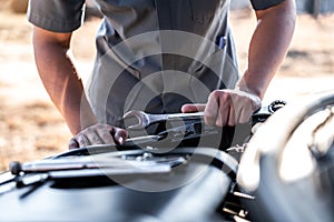 Technician hands of car mechanic in doing auto repair service and maintenance worker repairing vehicle with wrench, Service and