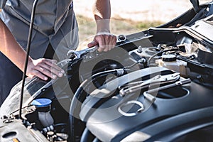 Technician hands of car mechanic in doing auto repair service and maintenance worker repairing vehicle with wrench, Service and