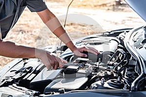 Technician hands of car mechanic in doing auto repair service and maintenance worker repairing vehicle with wrench, Service and