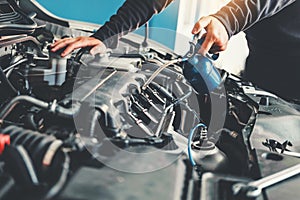 Technician Hands of car mechanic working in auto repair Service and Maintenance car