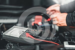 Technician Hands of car mechanic working in auto repair Service and Maintenance car battery