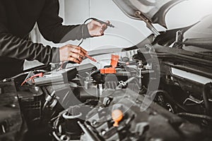 Technician Hands of car mechanic working in auto repair Service and Maintenance car battery