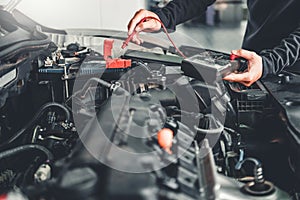 Technician Hands of car mechanic working in auto repair Service and Maintenance car battery