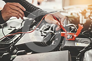 Technician Hands of car mechanic working in auto repair Service and Maintenance car battery