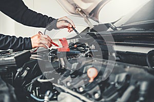 Technician Hands of car mechanic working in auto repair Service and Maintenance car battery