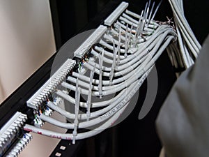Technician hands installing network cables in server rack