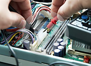 Technician hands with multimeter.
