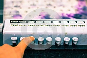 Technician hands pressing buttons of side view of pathological manual blood cell counter with buttons and display numbers