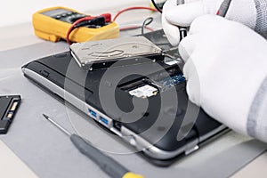 Technician hands repairing a laptop computer