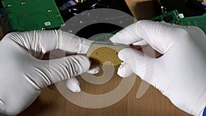 Technician hands with rubber gloves holding computer cpu