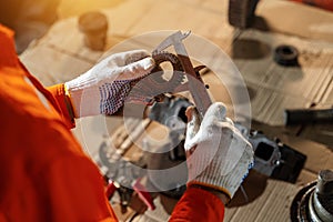 A technician holding of bulldozer sprocket to inspection and repair maintenance heavy machinery, Industrial Theme