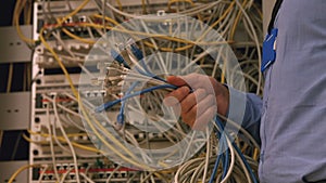 Technician holding bunch of cables