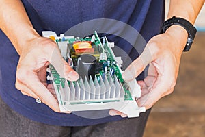 Technician holding computer electronic circuit board in the hand.