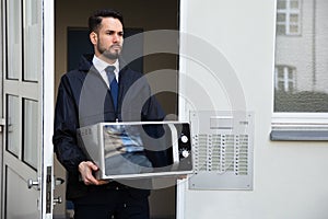 Technician Holding Microwave