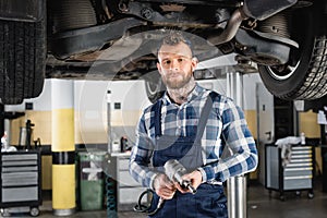 Technician holding pneumatic wrench while standing