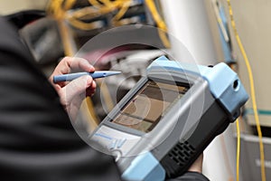 Technician holding reflectometer