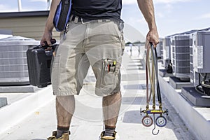 Technician with Hvac tools on Roof photo